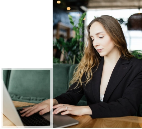 A professional woman focusing on her laptop while working on HND Health and Social Care academic assignments.